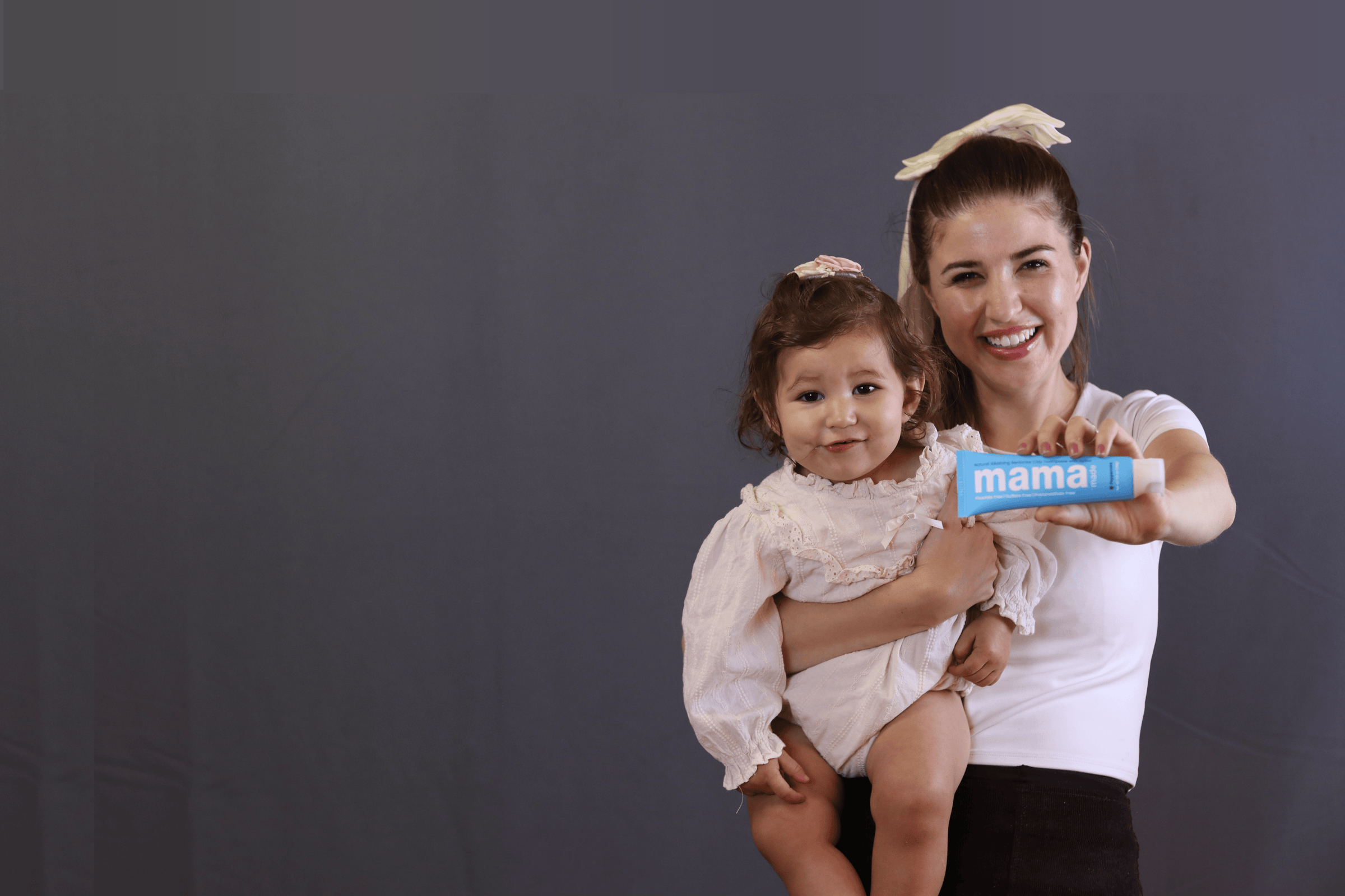 Woman and baby holding Mama Made 100% Natural Bentonite Clay Toothpaste Fluoride-free 